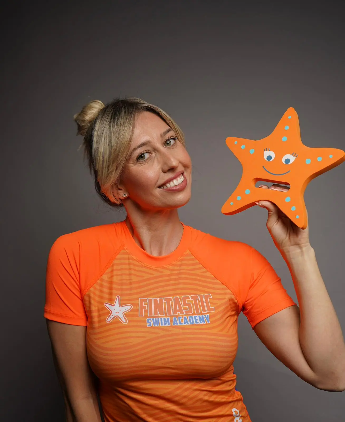 Fintastic Promo - Woman holding starfish floatie