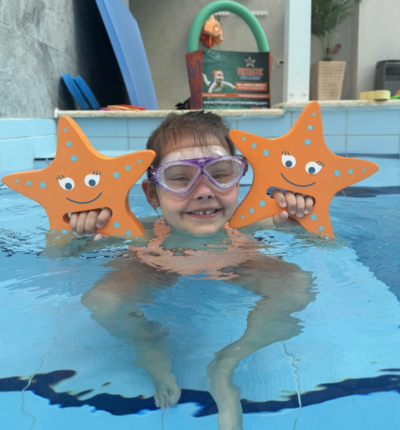 Young partygoer at a pool birthday party with Fintastic