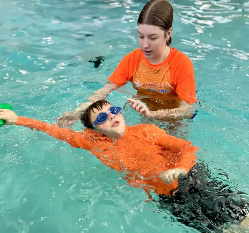 close up photo of a 7-year boy playing and swimming in the swimming pool