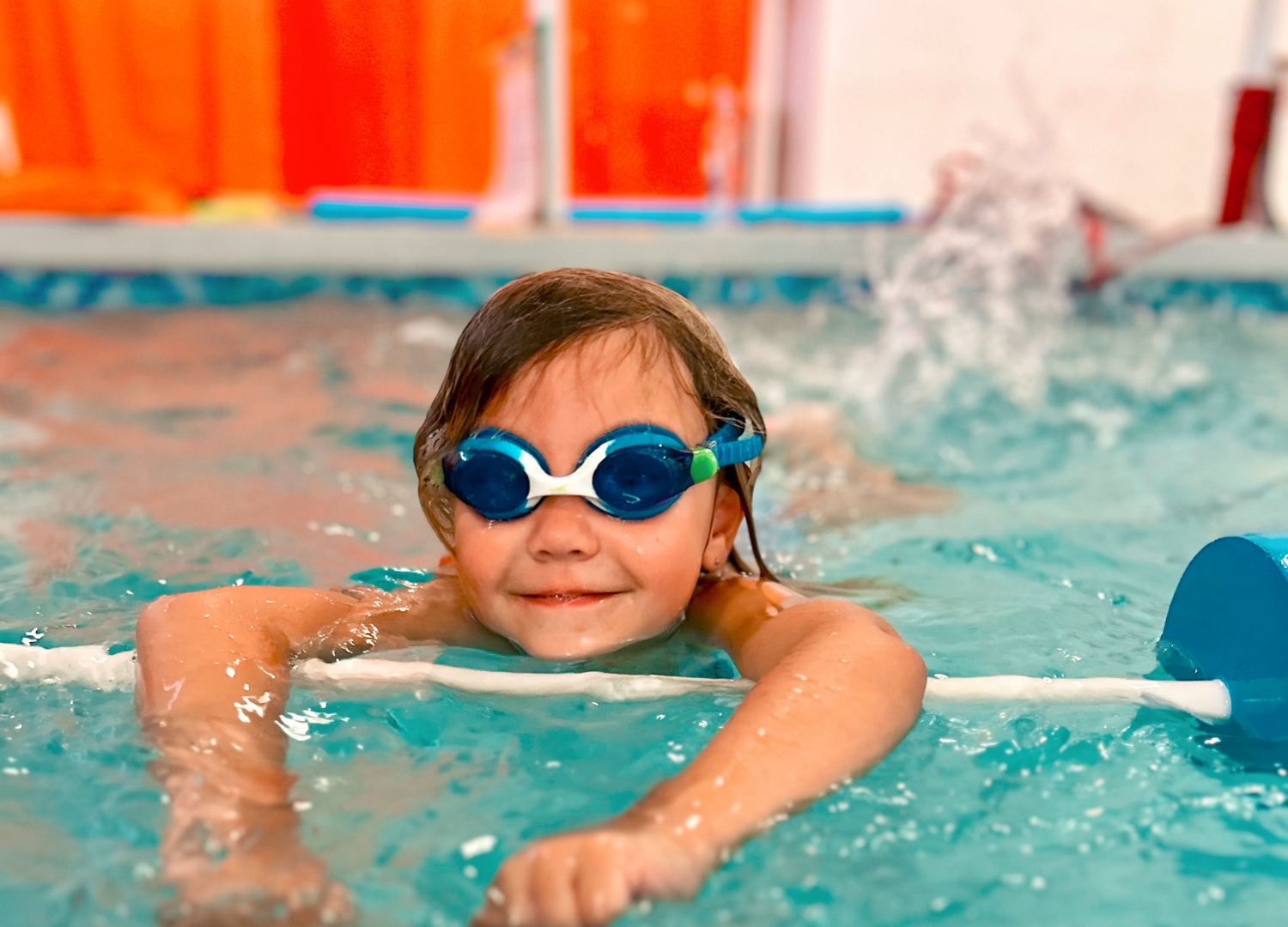 Baby boy dives underwater in the pool with pleasure