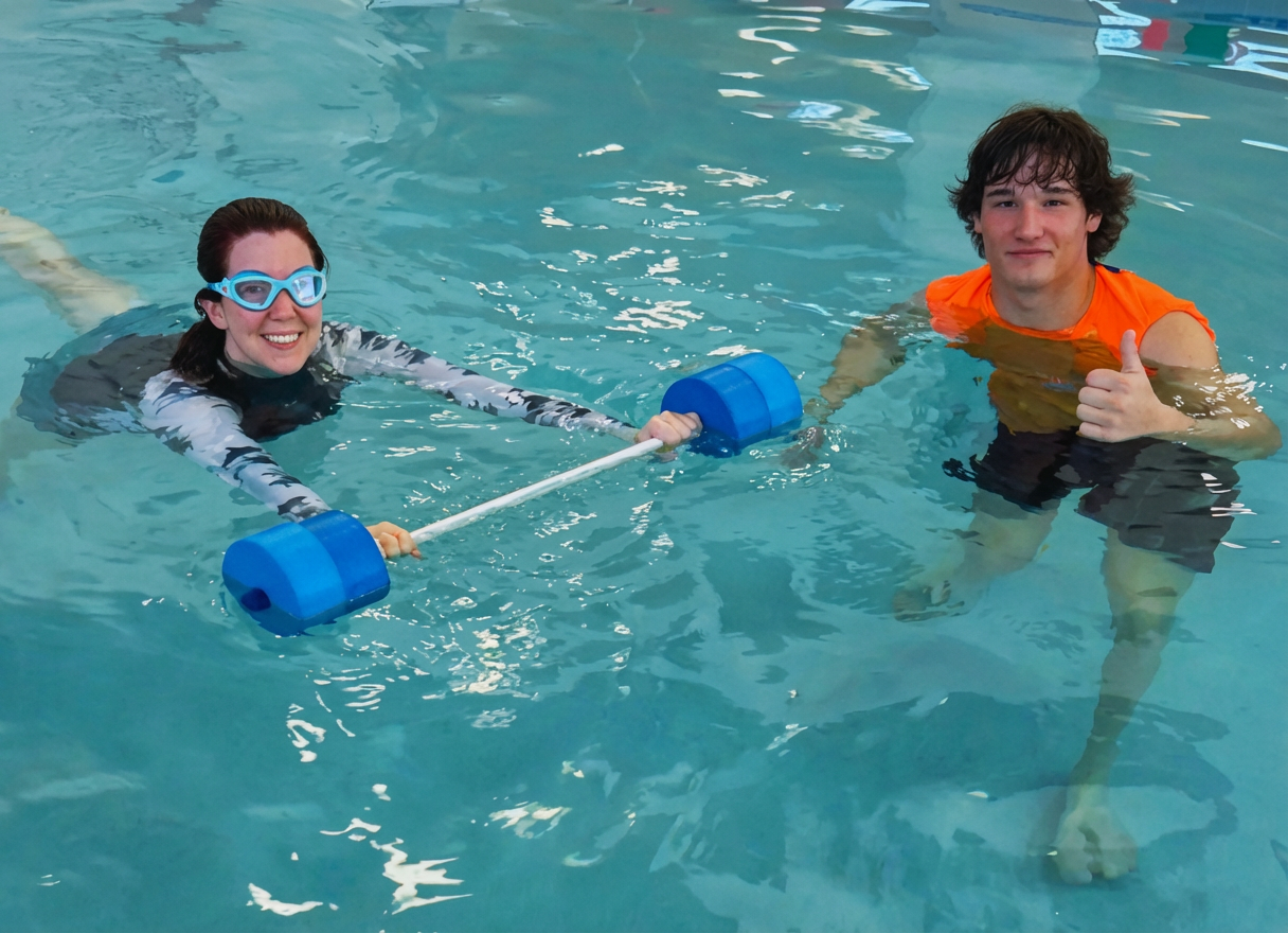 High angle view of cheerful trainers and senior swimmers in pool