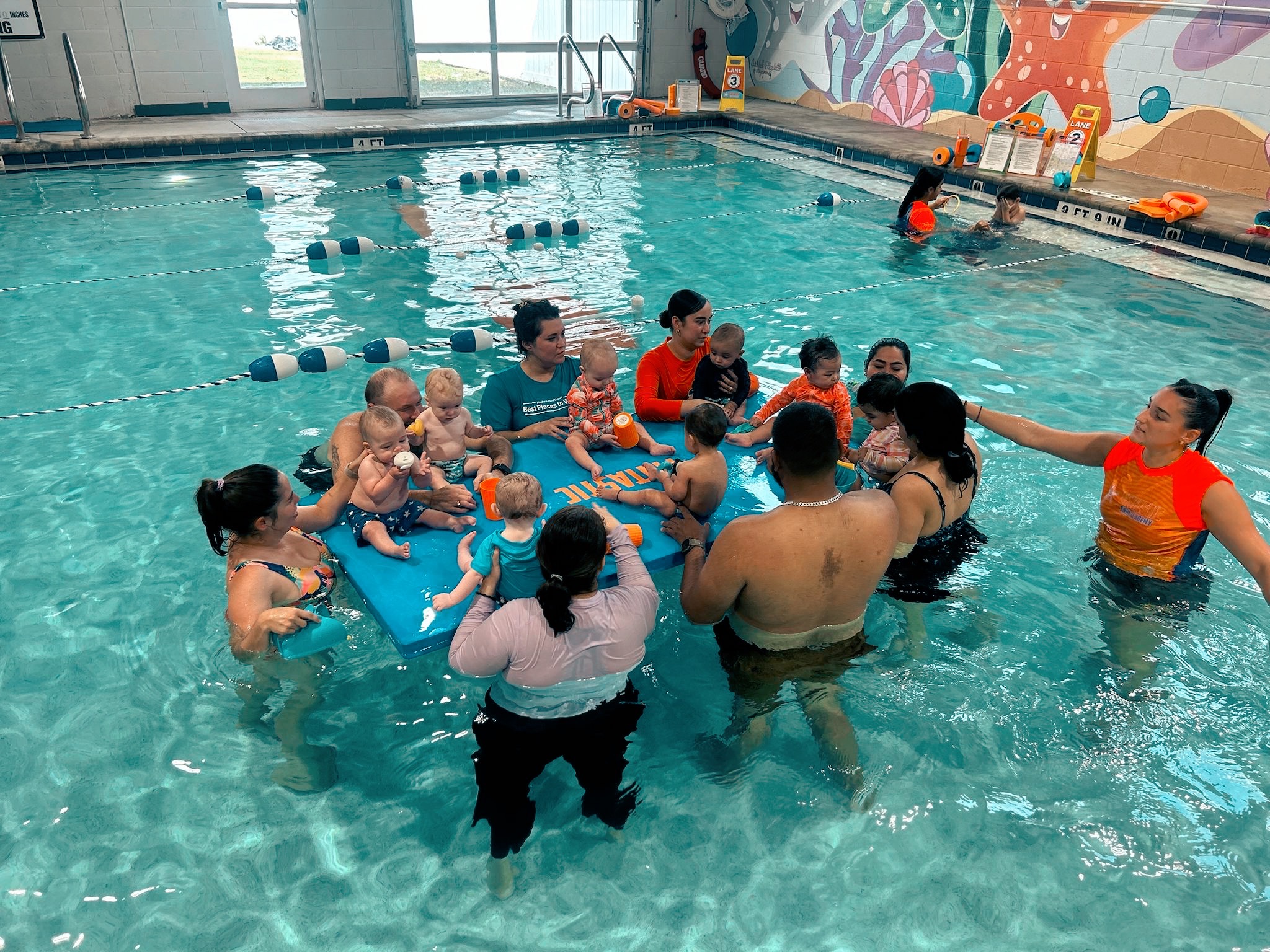 Baby boy dives underwater in the pool with pleasure